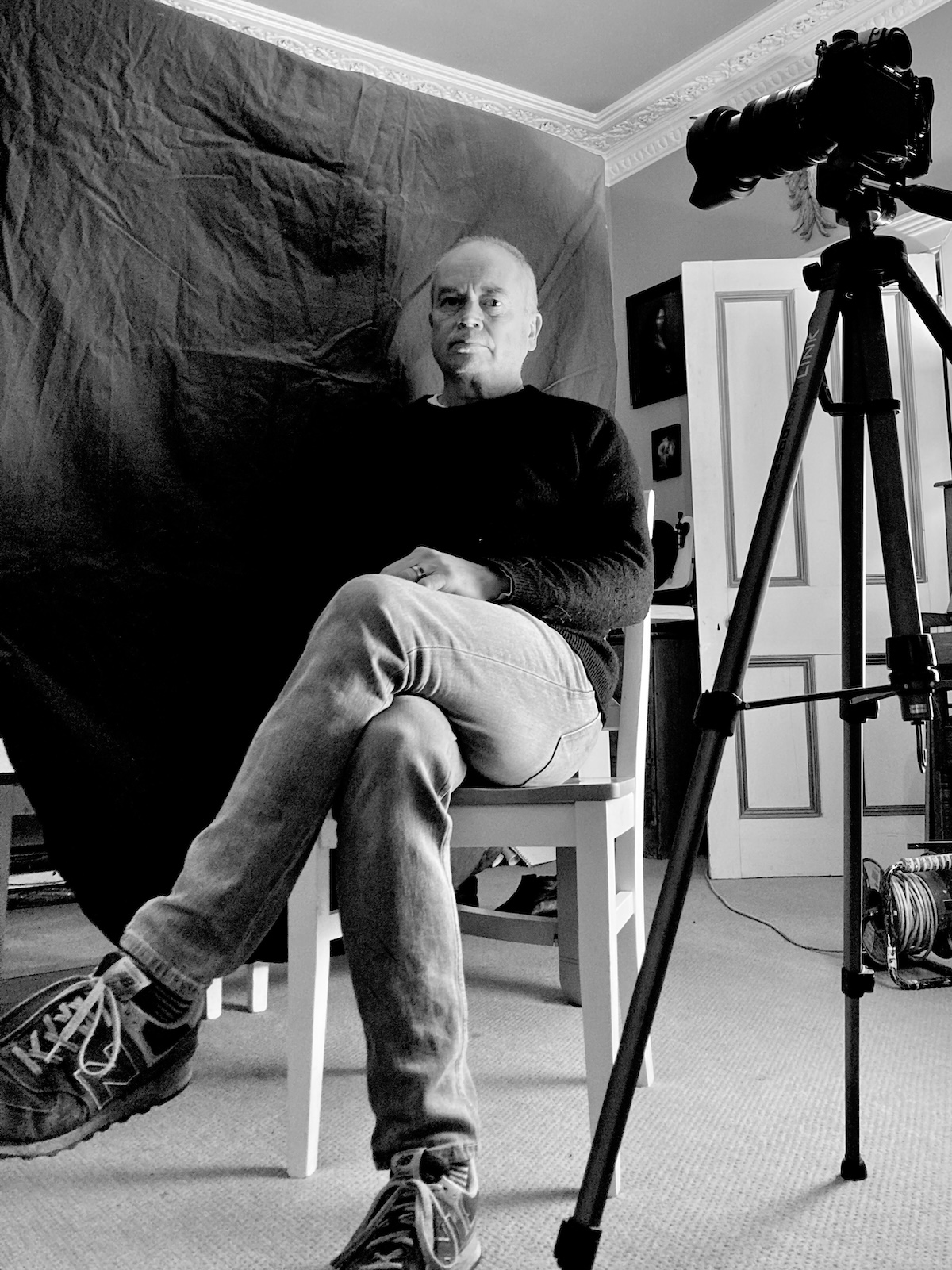 black and white image of Mano Collins taking a rest on a chair in a portrait shoot