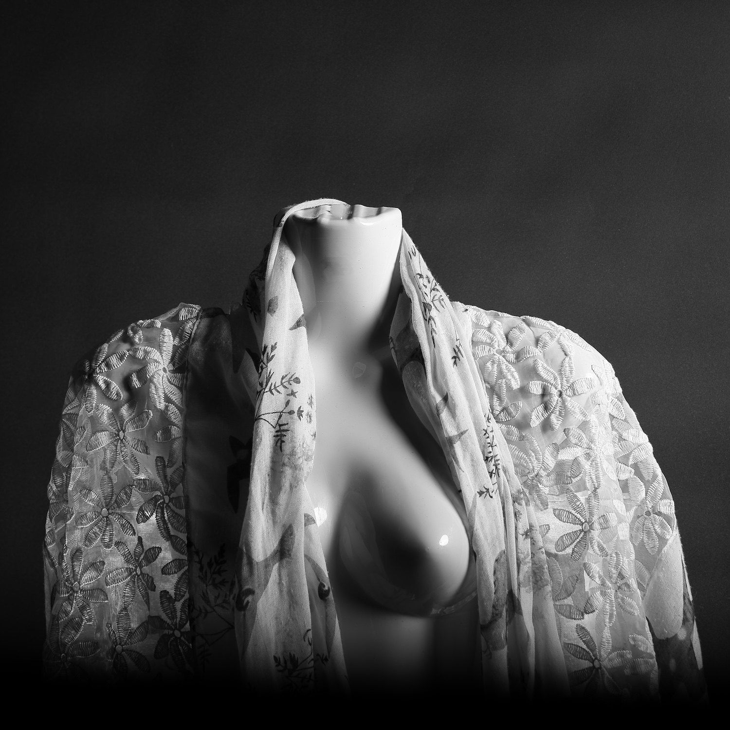 Shop window chest mannequin draped in scarf - black and white