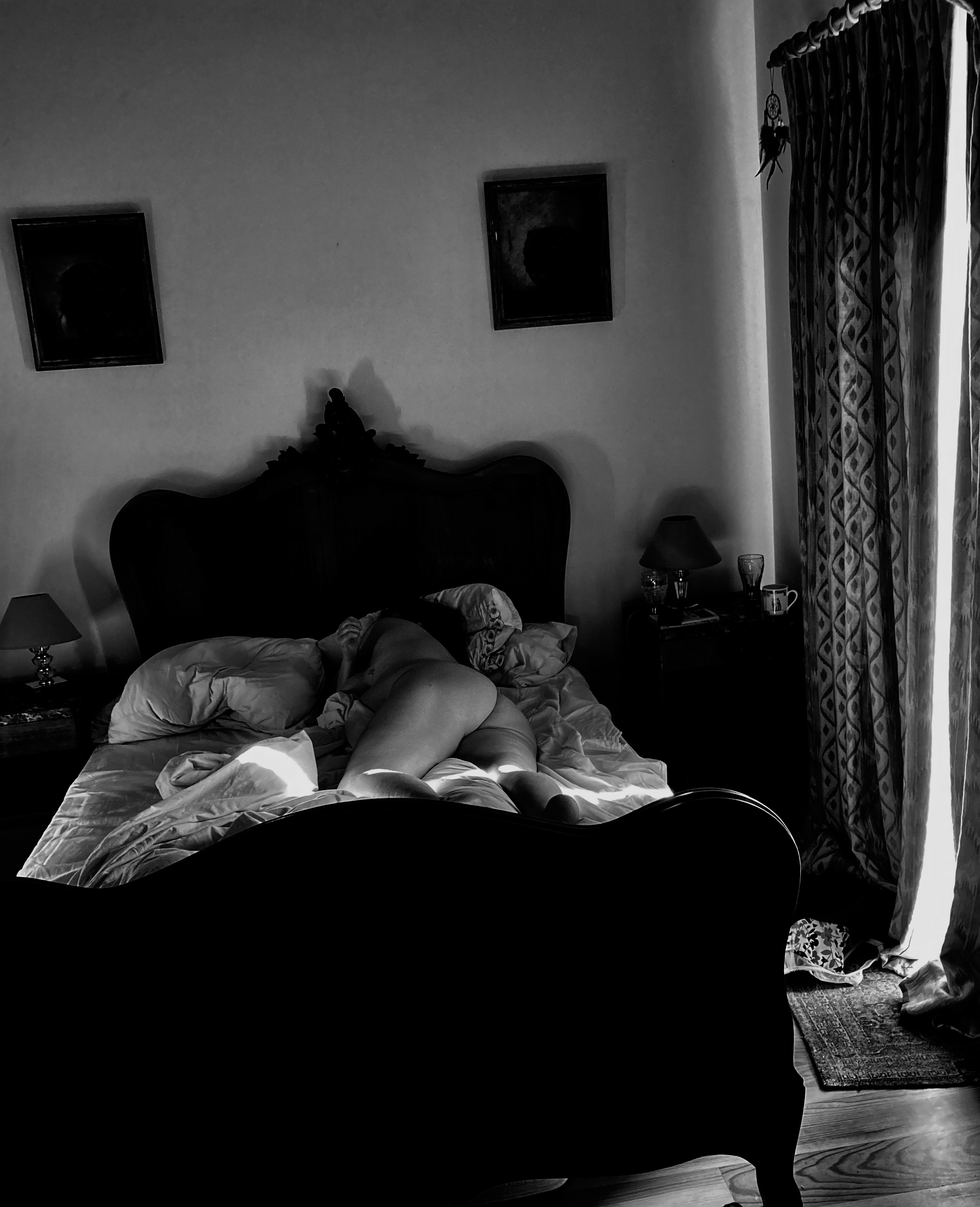 Naked sleeping woman in the morning with light coiing in the the side curtains