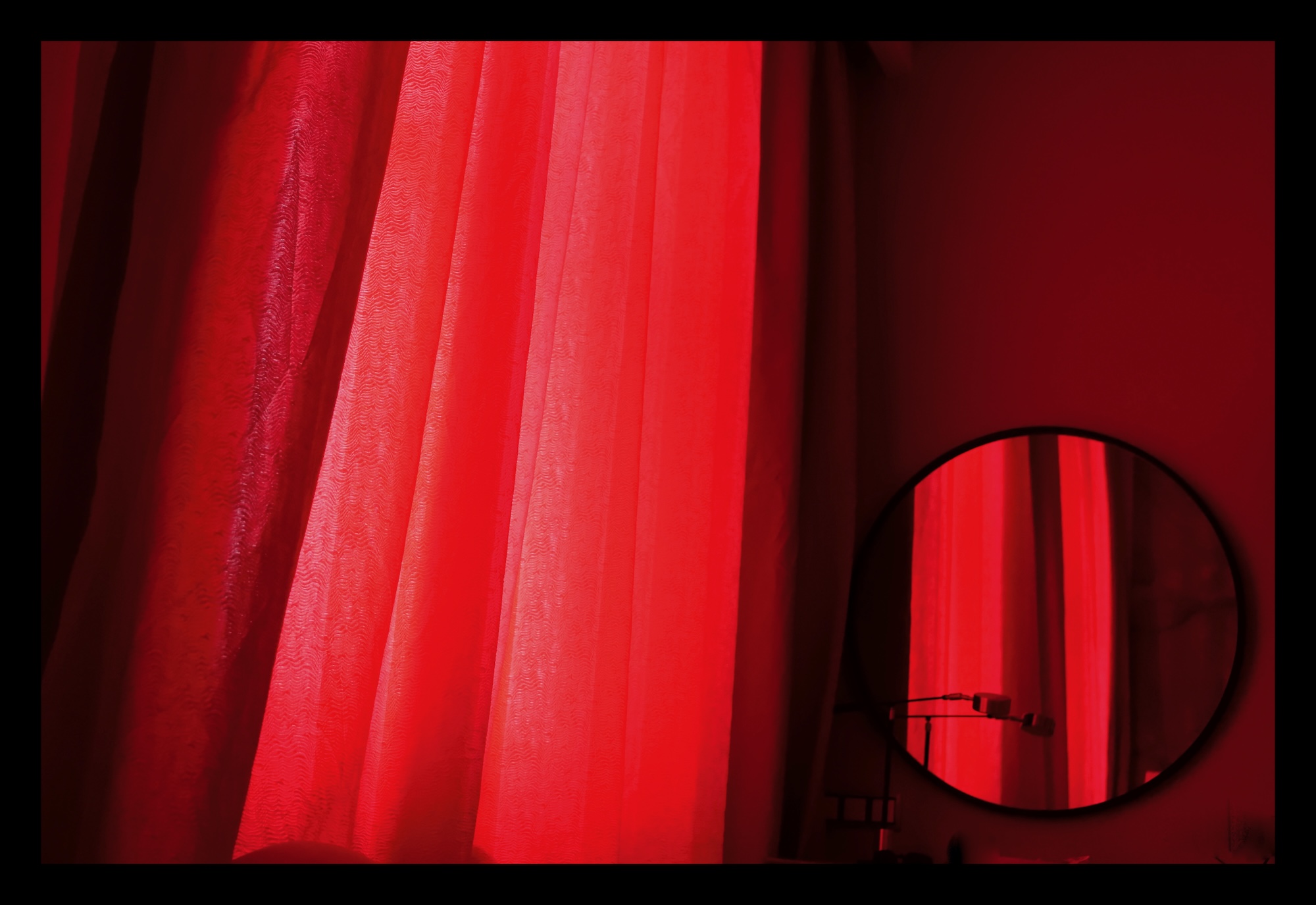 Red curtains shading and entire room in red light