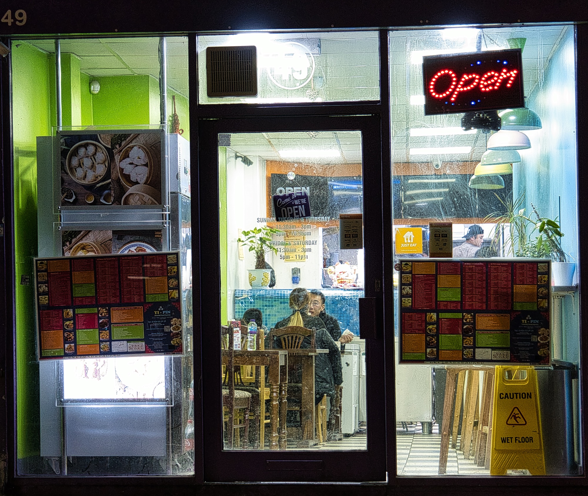 Late night view through the window of a chinese restaurany and take away